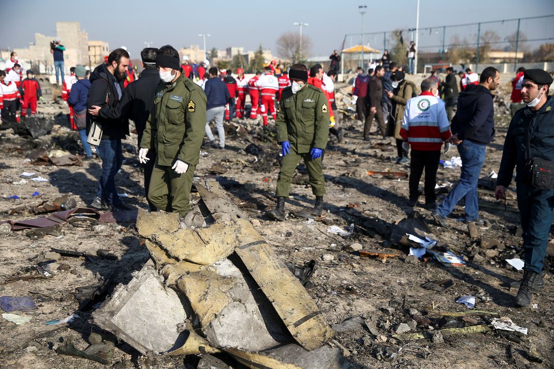 Oficiais de segurança e trabalhadores do Crescente Vermelho são vistos no local onde o avião da Ukraine International Airlines caiu após a decolagem do aeroporto Imam Khomeini, no Irã, nos arredores de Teerã, no Irã, em 8 de janeiro de 2020.