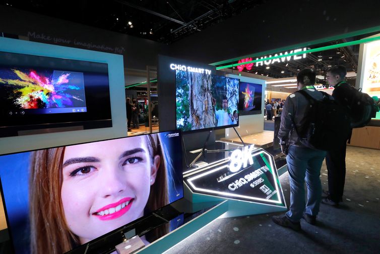 Attendees look over Changhong 8K CHiQ televisions during the 2019 CES in Las Vegas, Nevada, U.S. January 9, 2019. REUTERS/Steve Marcus