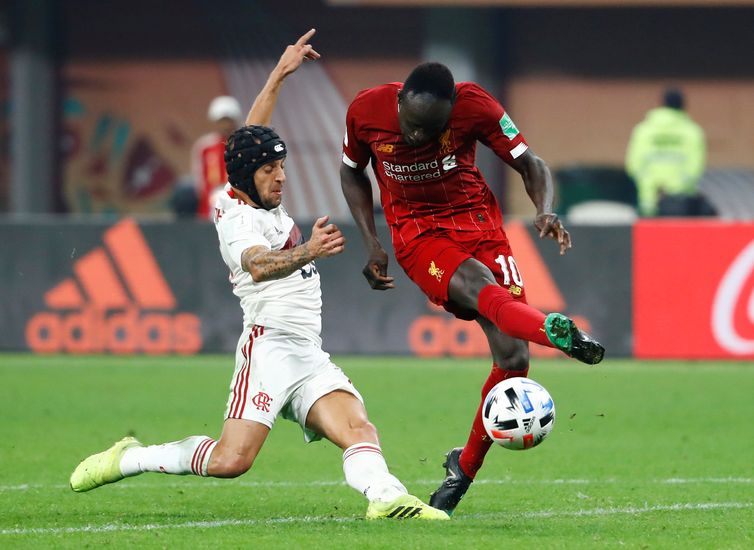 Soccer Football - Club World Cup - Final - Liverpool v Flamengo - Khalifa International Stadium, Doha, Qatar - December 21, 2019 Liverpool&#039;s Sadio Mane is fouled by Flamengo&#039;s Rafinha before the referee&#039;s decision is overturned following a
