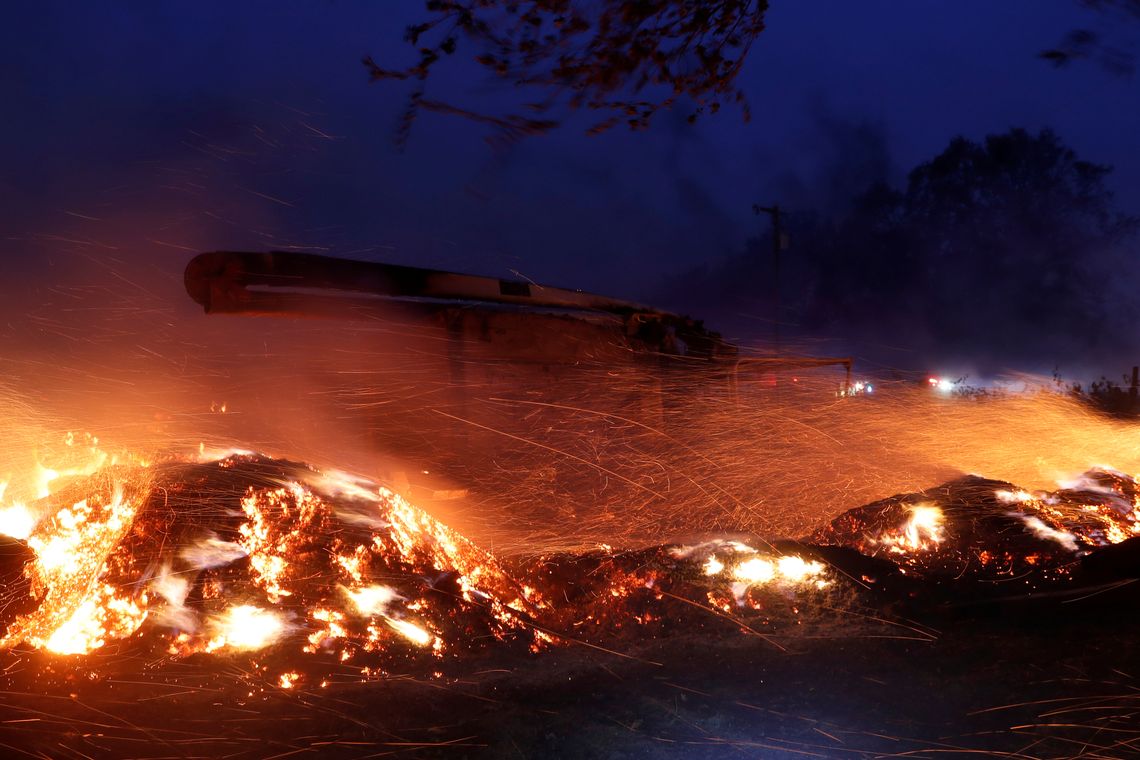 Brasas voam em torno de um caminhão  durante o incêndio em Healdsburg, Califórnia, EUA