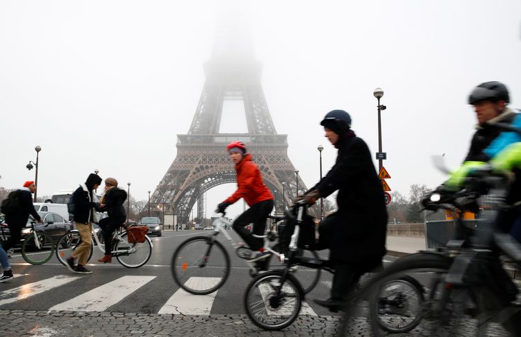 People ride bicycles near the Eiffel Tower during a strike by all unions of the Paris transport network (RATP) as part of a day of national strike and protests against French government's pensions reform plans, France, December 5, 2019.  REUTERS