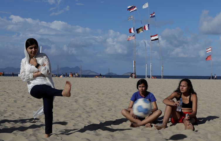 Nobel prize winner Malala Yousafzai plays a penalty kick during a meeting with teenage girls from Complexo da Penha who work with football organization Street Child United at Copacabana beach in Rio de Janeiro, Brazil July 11, 2018. REUTERS