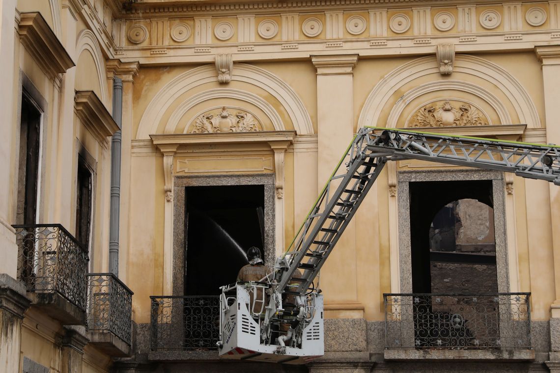 A firefighter sprays water at the National Museum of Brazil in Rio de Janeiro, Brazil September 3, 2018. REUTERS/Pilar Olivares