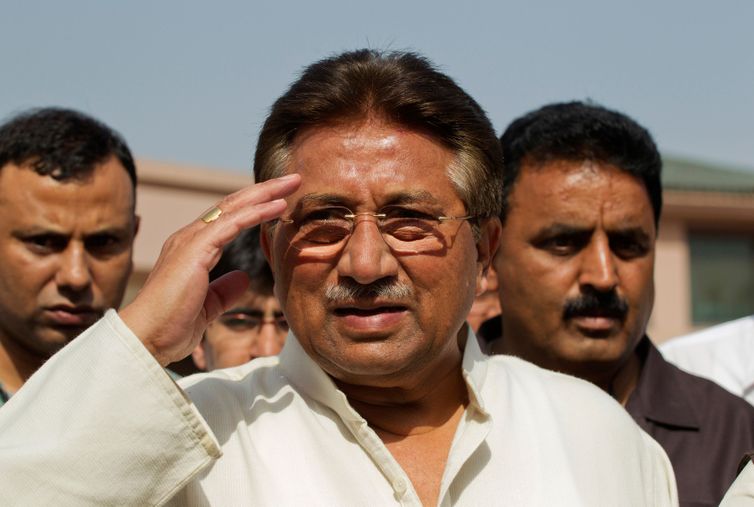 FILE PHOTO: Pakistan's former President and head of the All Pakistan Muslim League (APML) political party Pervez Musharraf salutes as he arrives to unveil his party manifesto for the forthcoming general election at his residence in Islamabad