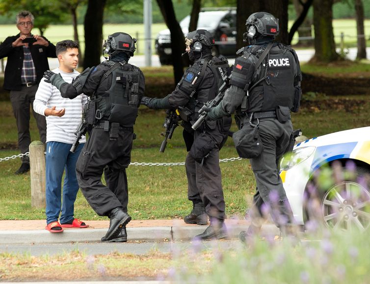 AOS (Armed Offenders Squad) empurra para trás membros do público após um tiroteio na mesquita Masjid Al Noor em Christchurch, Nova Zelândia, 15 de março de 2019.