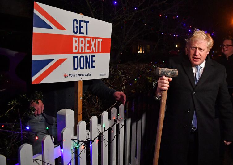 Britain's Prime Minister and Conservative party leader Boris Johnson poses with a sledgehammer, after hammering a &quot;Get Brexit Done&quot; sign into the garden of a supporter, in South Benfleet, Britain December 11, 2019. Ben Stansall/Pool via REUTERS