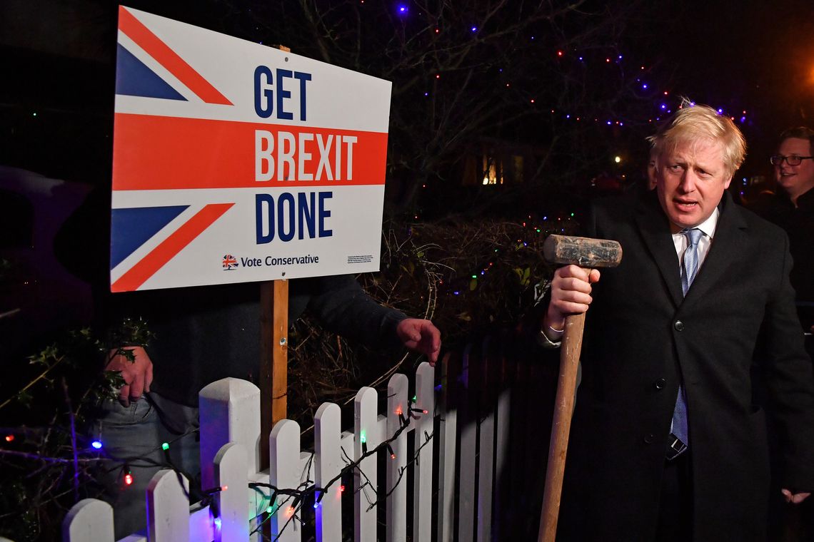 Britain's Prime Minister and Conservative party leader Boris Johnson poses with a sledgehammer, after hammering a "Get Brexit Done" sign into the garden of a supporter, in South Benfleet, Britain December 11, 2019. Ben Stansall/Pool via REUTERS