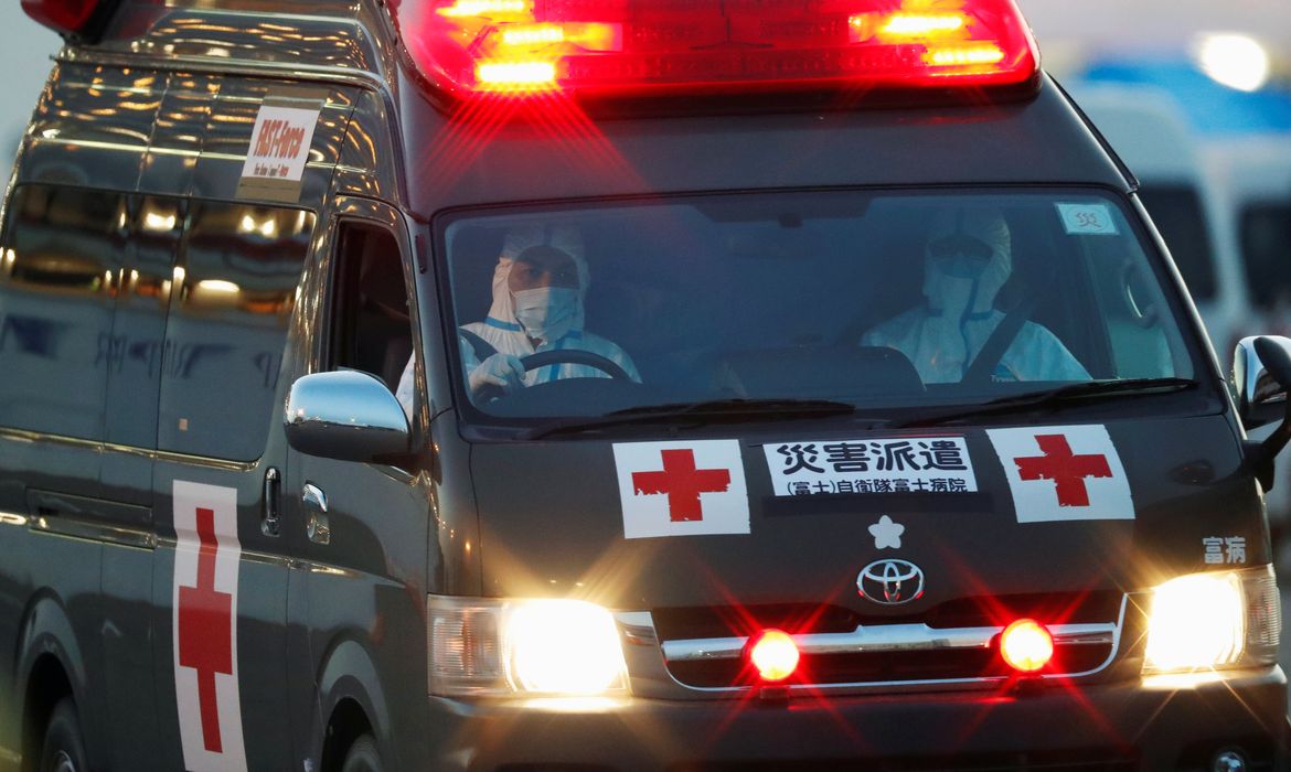An ambulance from Japanese Self-Defence Force leaves the pier where the cruise ship Diamond Princess is anchored, as dozens of passengers were tested positive for coronavirus on board, at Daikoku Pier Cruise Terminal in Yokohama