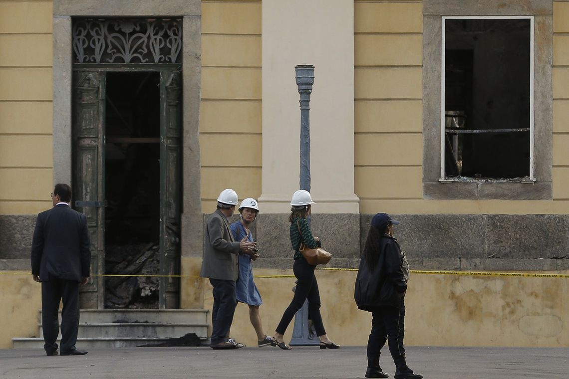 Fernando Frazão/Agência Brasil A chefe da missão da Unesco, Cristina Menegazzi (de vestido), chega para avaliar o resgate nos escombros e reconstrução do patrimônio no Museu Nacional do Rio de Janeiro, após o incêndio.