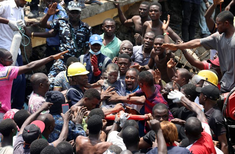 Men carry a boy who was rescued at the site of a collapsed building containing a school in Nigeria&#039;s commercial capital of Lagos, Nigeria March 13, 2019. REUTERS/Temilade Adelaja