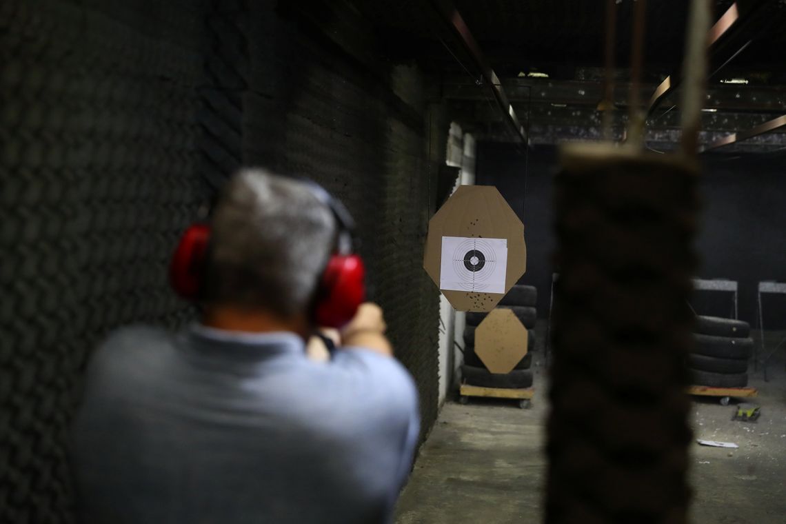 A member of the Colt 45 shooting club fires a gun in Rio de Janeiro, Brazil January 15, 2019. REUTERS/Pilar Olivares