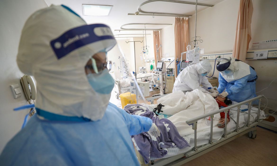 Medical workers in protective suits attend to a patient inside an isolated ward of Wuhan Red Cross Hospital in Wuhan, the epicentre of the novel coronavirus outbreak