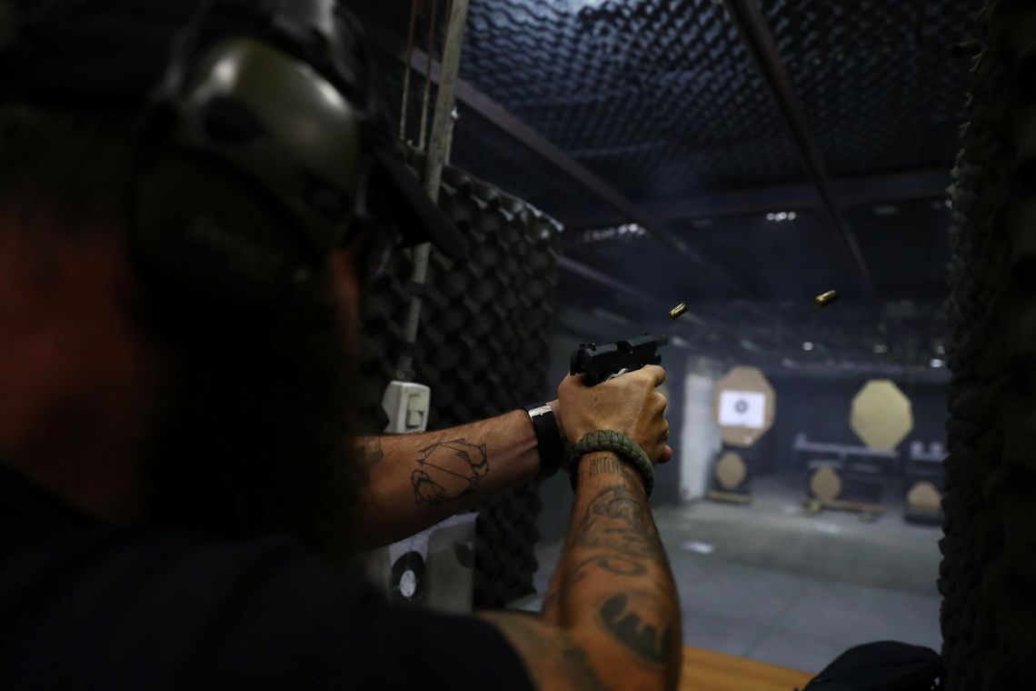 Joao Bercle, instructor of the Colt 45 shooting club, fires a gun, in Rio de Janeiro, Brazil January 15, 2019. REUTERS/Pilar Olivares