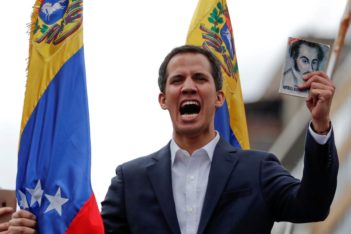 Juan Guaido, President of Venezuela&#039;s National Assembly, holds a copy of Venezuelan constitution during a rally against Venezuelan President Nicolas Maduro&#039;s government and to commemorate the 61st anniversary of the end of the dictatorship of