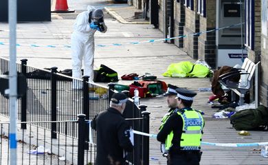 A forensic officer takes pictures at the cordoned-off area at Huntingdon Station, following a series of stabbings on a London North Eastern Railway (LNER) train, near Cambridge, Britain, November 2, 2025. REUTERS/Jack Taylor