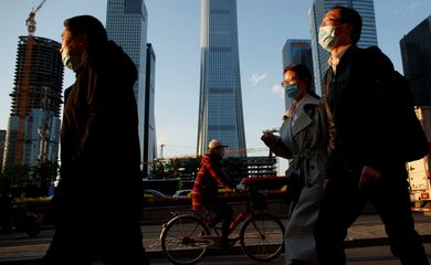 People wear protective masks as they leave work during evening rush hour in Beijing as the spread of the novel coronavirus disease (COVID-19) continues