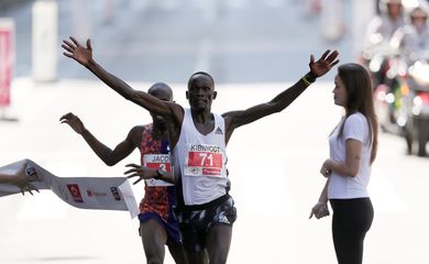 Kibiwott Kandie of Kenya crosses the finish line after passing Uganda's Jacob Kiplimo at the last moment to win the annual 