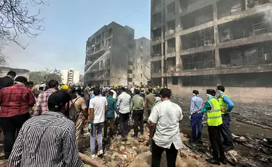People gather near the site where an Air India plane crashed in Ahmedabad, India, June 12, 2025. REUTERS/Amit Dave