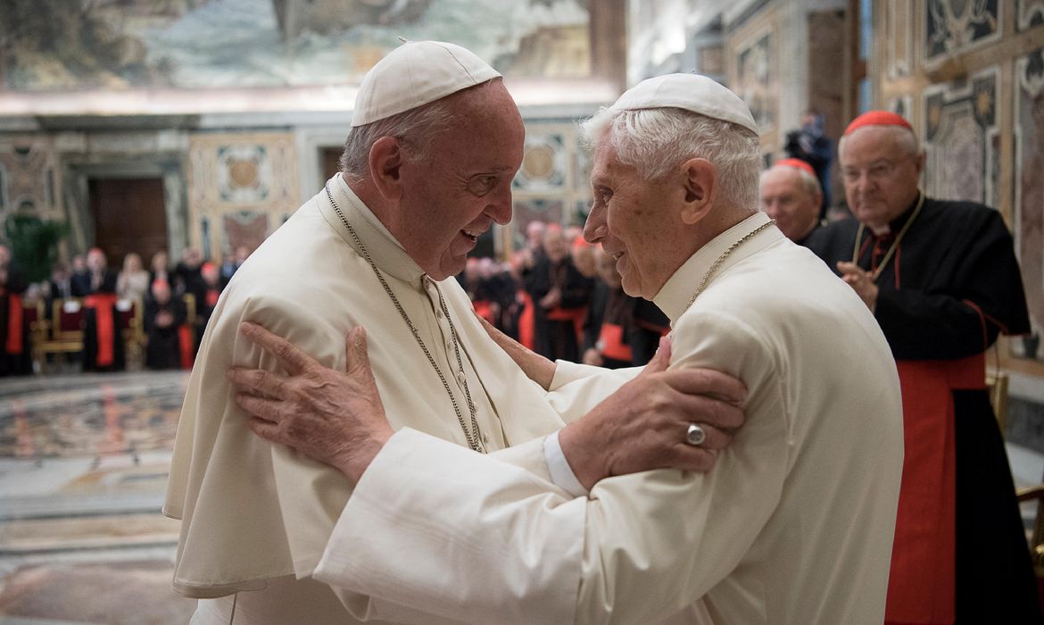 FILE PHOTO: Former pope Benedict is greeted by Pope Francis during a ceremony to mark his 65th anniversary of ordination to the priesthood at the Vatican
