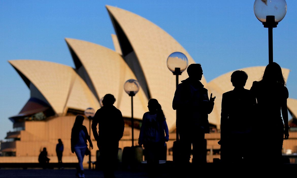 FILE PHOTO: People are silhouetted against the Sydney Opera House at sunset in Australia