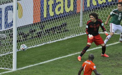 Mexico's goalkeeper Guillermo Ochoa looks to the ball as Netherlands' Wesley Sneijder scores his side's first goal during the World Cup round of 16 soccer match between the Netherlands and Mexico at the Arena Castelao i