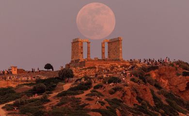 Flower Moon rises behind the Temple of Poseidon, before a lunar eclipse in Cape Sounion