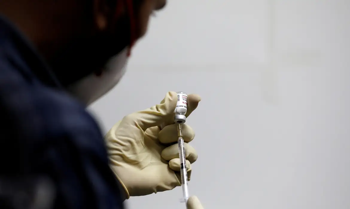 FILE PHOTO: A medic fills a syringe with COVAXIN, an Indian government-backed experimental COVID-19 vaccine, before administering it to a health worker during its trials, in Ahmedabad