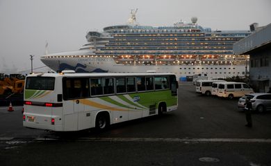A bus arrives at the cruise ship Diamond Princess at Daikoku Pier Cruise Terminal in Yokohama