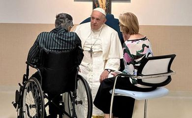 Pope Francis speaks to a person during his visit to the paediatric oncology department of Gemelli hospital, in Rome, June 15, 2023. REUTERS/Vatican Media