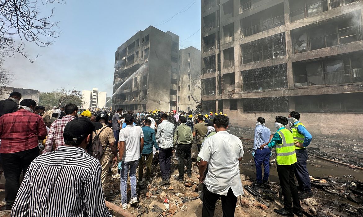 People gather near the site where an Air India plane crashed in Ahmedabad, India, June 12, 2025. REUTERS/Amit Dave