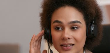 Ouvidoria – mulher atende chamada por meio de um headset 