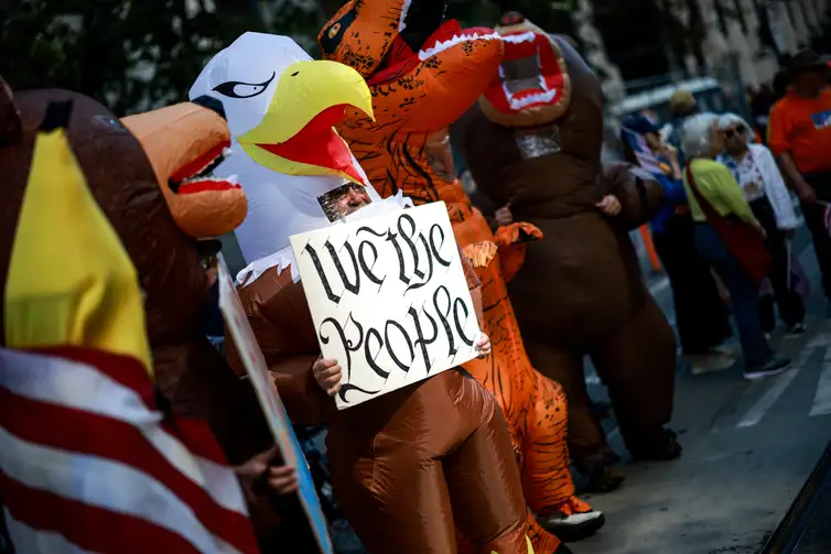People wear inflatable costumes during a 