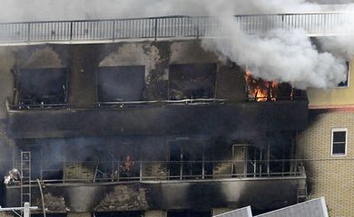 An aerial view shows smoke and flame rise from the three-story Kyoto Animation building which was torched in Kyoto, western Japan, in this photo taken by Kyodo July 18, 2019. Mandatory credit Kyodo/via REUTERS ATTENTION EDITORS - THIS IMAGE WAS