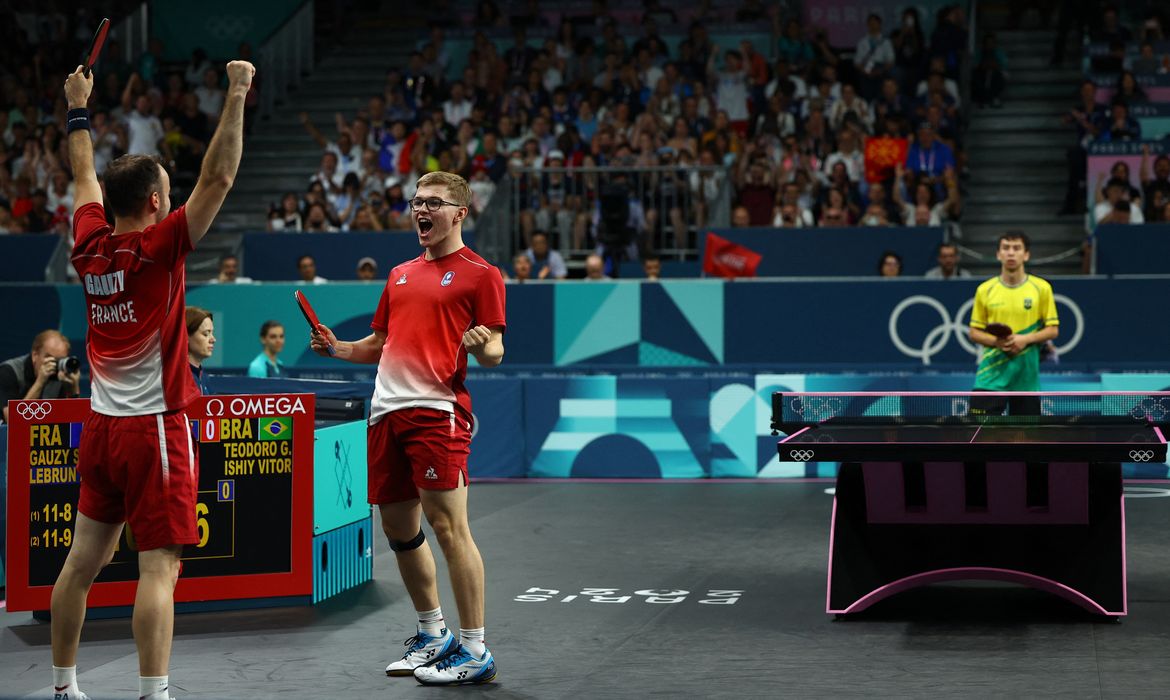 Paris 2024 Olympics - Table Tennis - Men's Team Quarterfinals - South Paris Arena 4, Paris, France - August 07, 2024.
Simon Gauzy of France and Alexis Lebrun of France celebrate after winning their quarterfinal match against Vitor Ishiy of Brazil and Guilherme Teodoro of Brazil. REUTERS/Kim Hong-Ji