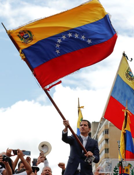 Juan Guaido, President of Venezuela's National Assembly, waves Venezuelan flag during a rally against Venezuelan President Nicolas Maduro's government and to commemorate the 61st anniversary of the end of the dictatorship of Marcos Perez Jimenez