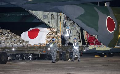 Japan Self-Defense Forces officers load relief supplies to be deployed to Tonga, in Komaki