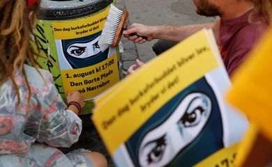 Cartazes alertam as pessoas sobre um protesto contra a proibição da burca em Copenhague, na Dinamarca