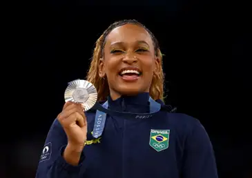 Paris 2024 Olympics - Artistic Gymnastics - Women's All-Around Victory Ceremony - Bercy Arena, Paris, France - August 01, 2024.
Silver medallist Rebeca Andrade of Brazil celebrates on the podium. REUTERS/Hannah Mckay