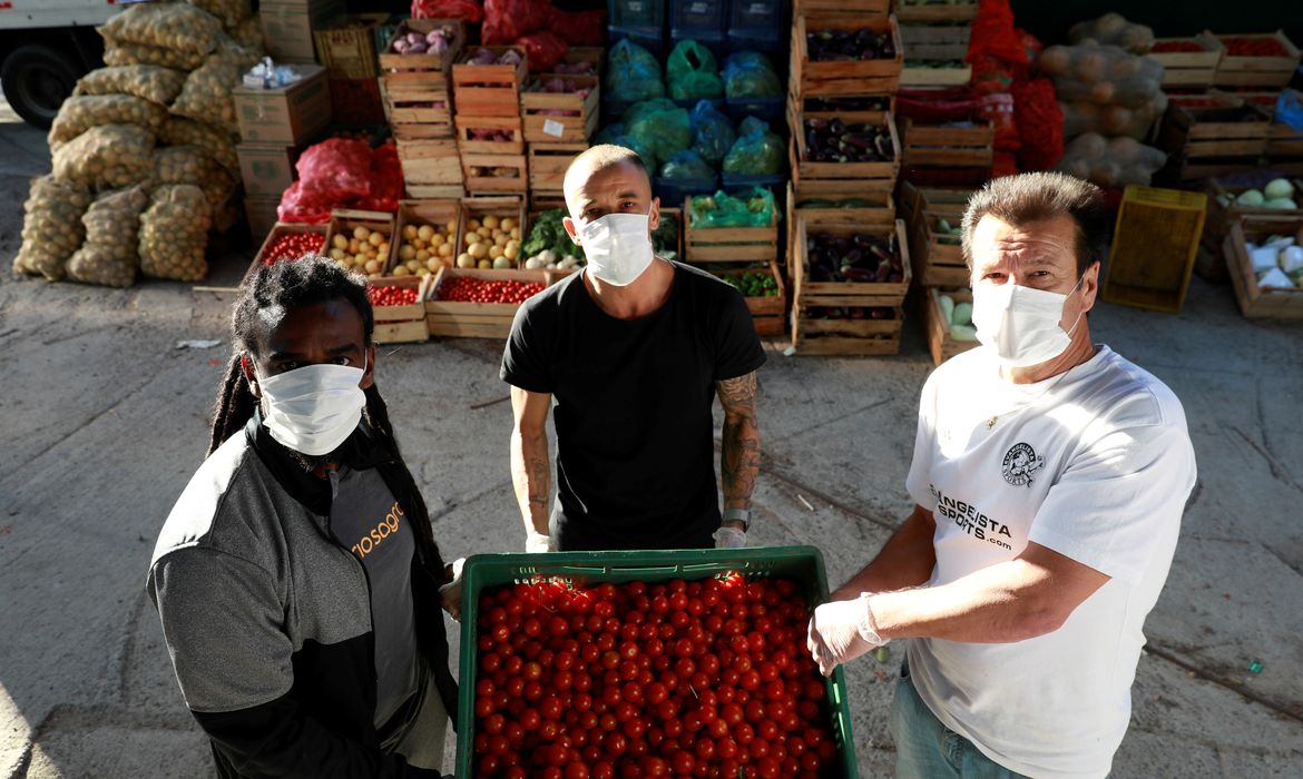 Former Brazil's head soccer coach Dunga, Internacional's soccer club player D'Alessandro and former soccer player Tinga help with food distribution to poor people, amid the coronavirus disease (COVID-19) outbreak, in Porto Alegre