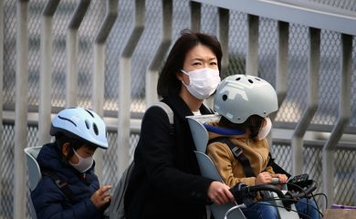 People, wearing protective masks following an outbreak of the coronavirus disease (COVID-19), are pictured in Tokyo