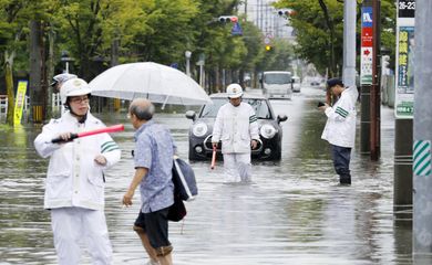 Policiais checam uma rua submersa em uma área inundada em Saga, província de Saga, sul do Japão, 28 de agosto de 2019