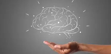 Mão em cunha finge apoiar o desenho estilizado de um cérebro