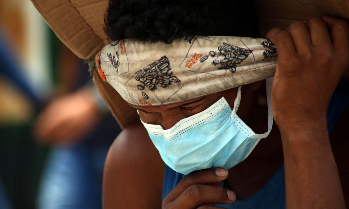 Homem com máscara de proteção atravessa ponte em Cúcuta. Colômbia relata primeiros casos de coronavírus entre povos indígenas