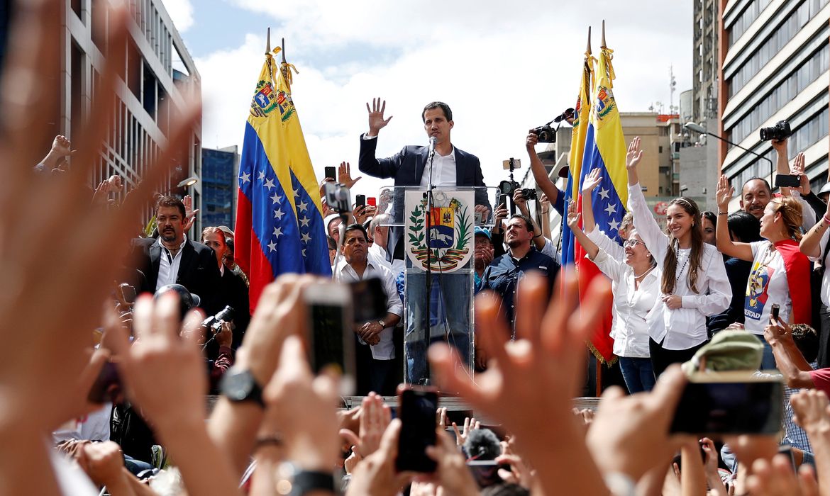 Juan Guaido, President of Venezuela's National Assembly, gestures during a rally against Venezuelan President Nicolas Maduro's government and to commemorate the 61st anniversary of the end of the dictatorship of Marcos Perez Jimenez in Caracas,