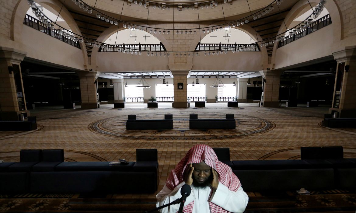 A cleric calls for the prayer at an empty Al-Rajhi Mosque, as Friday prayers were suspended following the spread of the coronavirus disease (COVID-19), in Riyadh