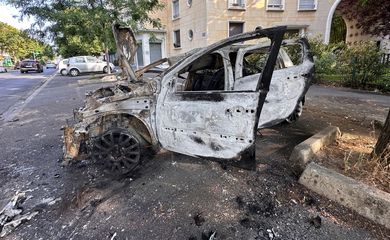 A car, burnt during clashes between youths and police, is seen in a street the day after the death of a 17-year-old teenager killed by a French police officer during a traffic stop, in Nanterre, Paris suburb, France, June 28, 2023. REUTERS