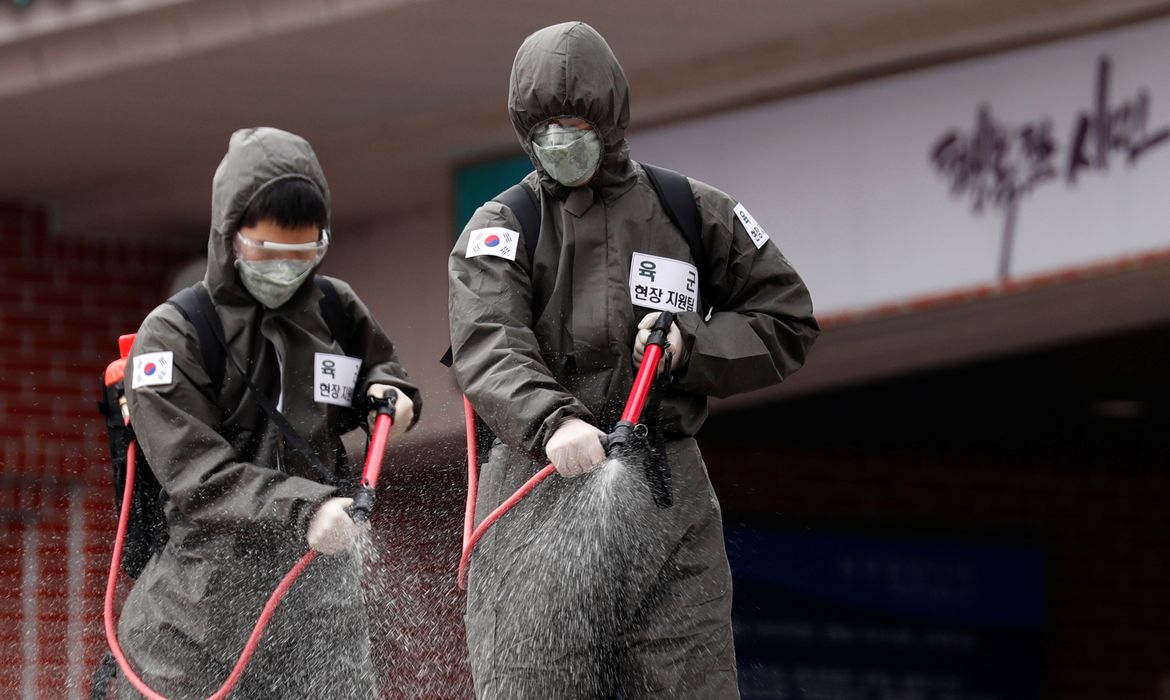 South Korean soldiers spray disinfectants inside an apartment complex which is under cohort isolation after mass infection of coronavirus disease (COVID-19) in Daegu