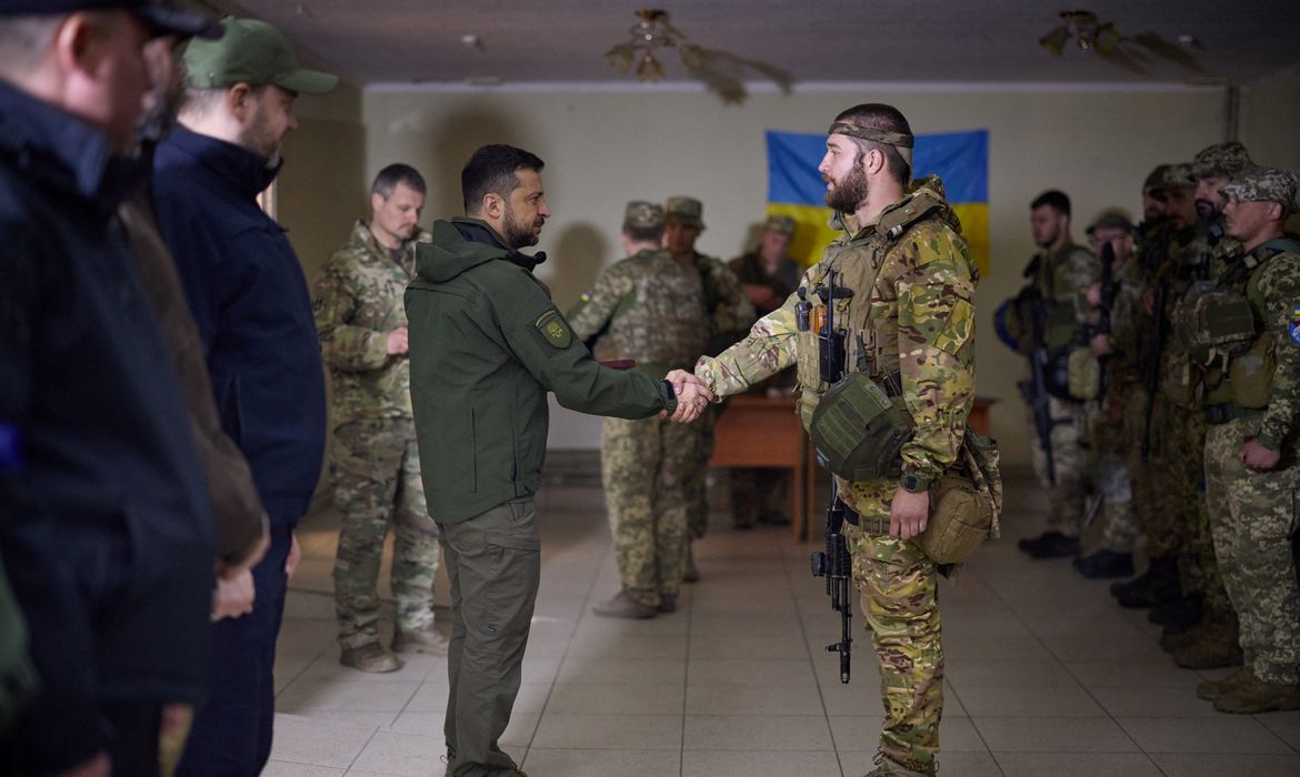 Ukraine's President Zelenskiy awards a Ukrainian service member near a frontline in Kharkiv region