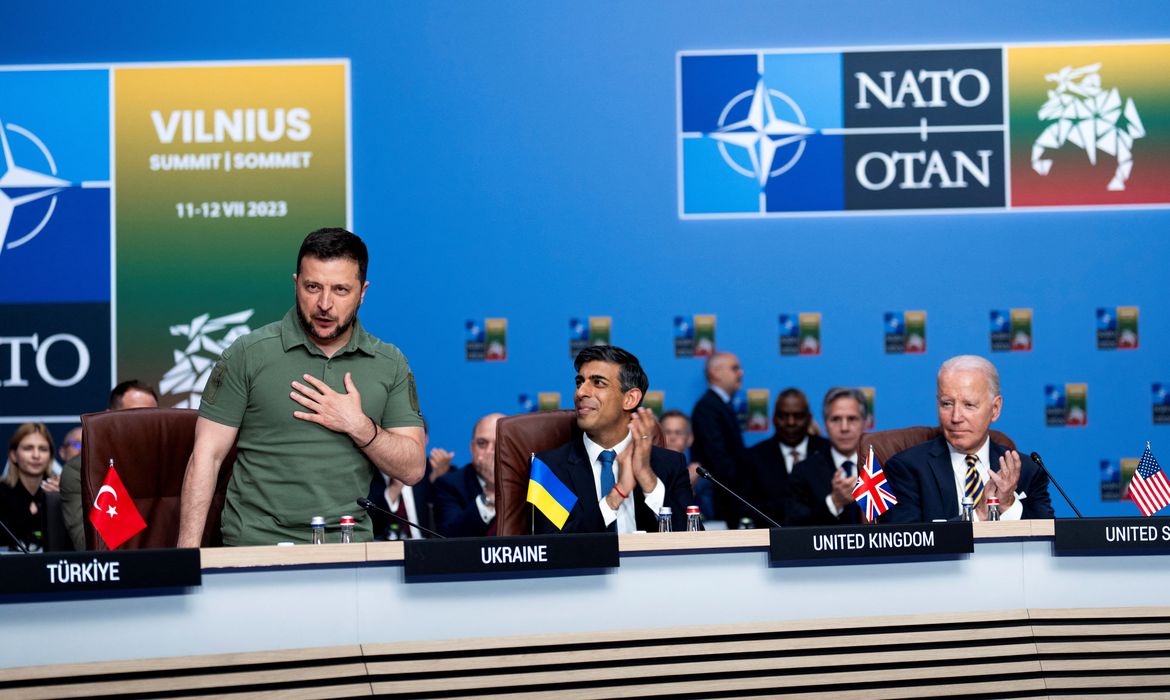 President Volodymyr Zelenskiy of Ukraine receives applause from NATO members, including British Prime Minister Rishi Sunak and President Joe Biden, during a meeting of the NATO-Ukraine Council at the level of Heads of State and Government, with Sweden, at the NATO Summit in Vilnius, Lithuania, Wednesday, July 12, 2023.  Doug Mills/Pool via REUTERS