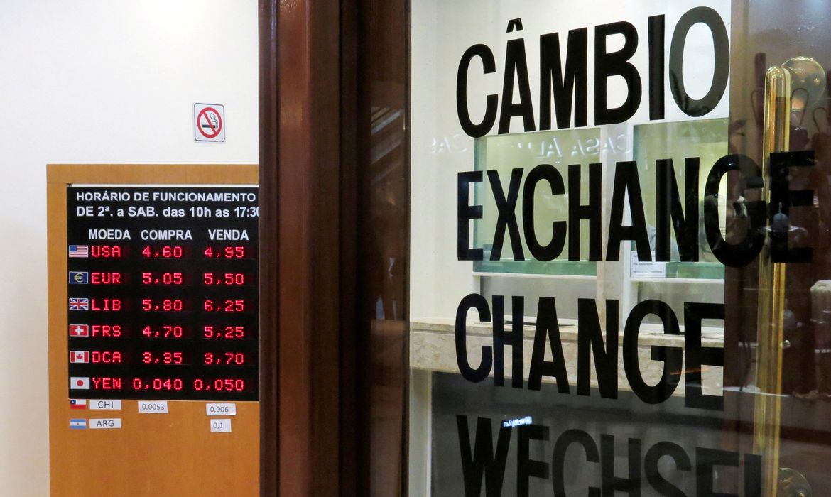 FILE PHOTO: A board displays the Brazilian Real-U.S. dollar and other exchange rates in Sao Paulo